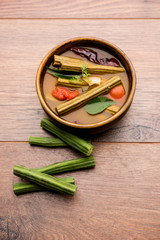 Drumstick Curry or Shevga sheng bhaji or south indian Sambar, served in a bowl over moody background. Selective focus