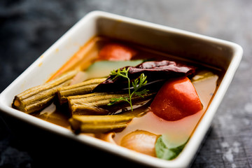 Drumstick Curry or Shevga sheng bhaji or south indian Sambar, served in a bowl over moody background. Selective focus