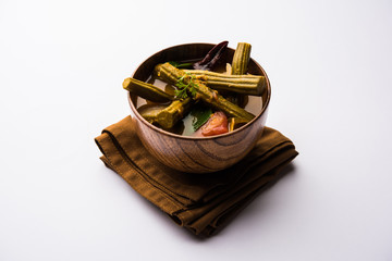 Drumstick Curry or Shevga sheng bhaji or south indian Sambar, served in a bowl over moody...