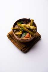 Drumstick Curry or Shevga sheng bhaji or south indian Sambar, served in a bowl over moody background. Selective focus