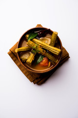 Drumstick Curry or Shevga sheng bhaji or south indian Sambar, served in a bowl over moody background. Selective focus