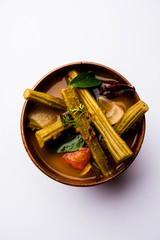 Drumstick Curry or Shevga sheng bhaji or south indian Sambar, served in a bowl over moody background. Selective focus