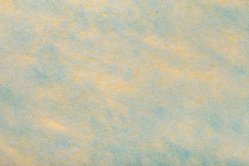Lght yellow and blue background of felt fabric. Texture of woolen textile