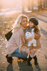 mom and daughter look into the camera