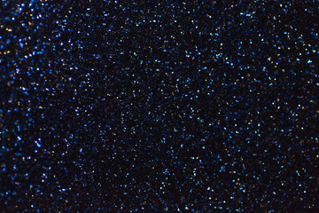 Blurred shiny navy blue background with sparkling lights.