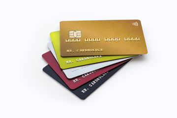 Stack of multicolored credit cards on white background
