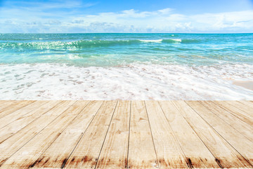 Fototapeta na wymiar Wooden on Soft Wave Of Blue Ocean On Sandy Beach.