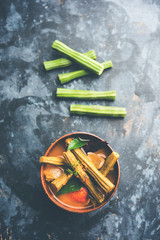 Drumstick Curry or Shevga sheng bhaji or south indian Sambar, served in a bowl over moody...