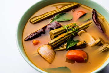 Drumstick Curry or Shevga sheng bhaji or south indian Sambar, served in a bowl over moody background. Selective focus