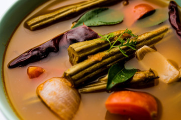 Drumstick Curry or Shevga sheng bhaji or south indian Sambar, served in a bowl over moody background. Selective focus