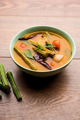 Drumstick Curry or Shevga sheng bhaji or south indian Sambar, served in a bowl over moody background. Selective focus