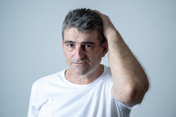 Sad and desperate mature handsome man feeling depressed in Facial expressions and depression