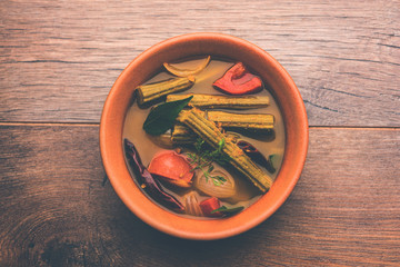 Drumstick Curry or Shevga sheng bhaji or south indian Sambar, served in a bowl over moody...