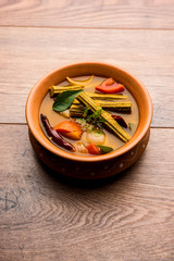 Drumstick Curry or Shevga sheng bhaji or south indian Sambar, served in a bowl over moody background. Selective focus