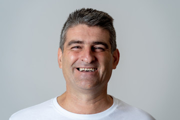 Close up portrait of a smiling and laughing mature man in happy face human emotions and expressions