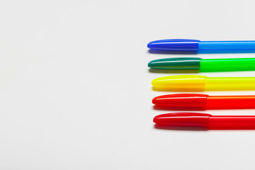 different colors pens isolated on the white background