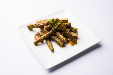 Drumstick masala or Shevga sheng sukhi sabji, served in a plate over moody background. Selective...