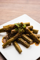 Drumstick masala or Shevga sheng sukhi sabji, served in a plate over moody background. Selective focus