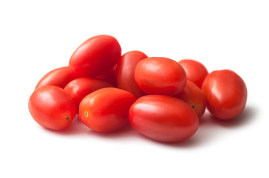 closeup of mini organic tomatoes roma on white background