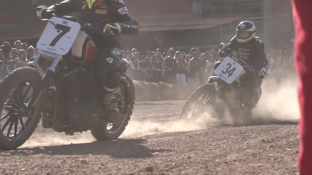 motorcycle riders passing finish line on dirt racing track on daylight slow motion 120fps