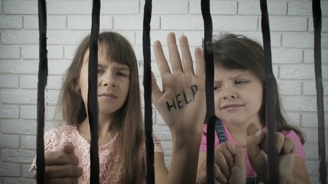 Children behind bars ask for help.