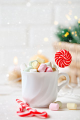 Merry Christmas and happy New year. Cup of cocoa and marshmallows on a light background. Background with copy space. Selective focus. Christmas background.