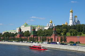 Summer view of the Moscow Kremlin, the Kremlin embankment and a pleasure boat, Russia