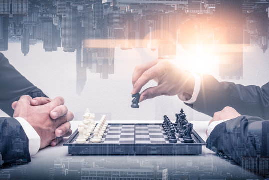 double exposure image of both businessmen playing the chess board game and overlay with cityscape image. the concept of accounting, business, financial, economy and investment.