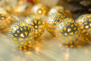 The gold Christmas ball  on  white  wood  table background.
