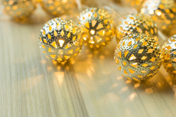The gold Christmas ball  on  white  wood  table background.