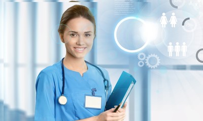 Attractive young female doctor with blurred hospital interior on