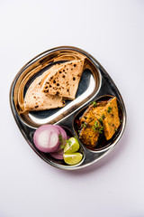 Patodi Rassa Bhaji or patwadi Sabji, a popular Maharashtrian spicy recipe served with Chapati and salad. Selective focus