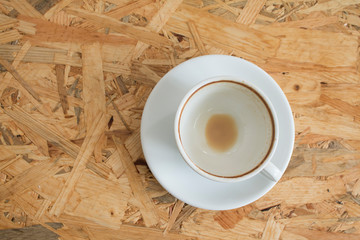 Closeup of Empty white coffee's cup after drink on wooden table