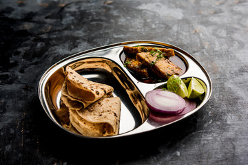 Patodi Rassa Bhaji or patwadi Sabji, a popular Maharashtrian spicy recipe served with Chapati and salad. Selective focus