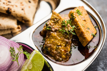 Patodi Rassa Bhaji or patwadi Sabji, a popular Maharashtrian spicy recipe served with Chapati and salad. Selective focus