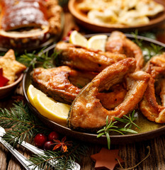 Fried carp fish slices on a ceramic plate, close up. Traditional christmas eve dish. Polish Christmas food