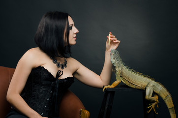 Beautiful sensual woman and dragon in the studio.