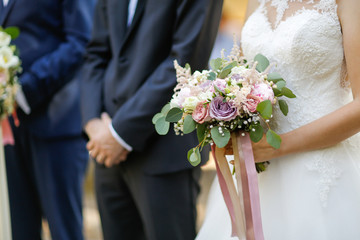 Close up with hands of groom and bride