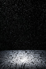 Fototapeta na wymiar Dark background shot of rain falling
