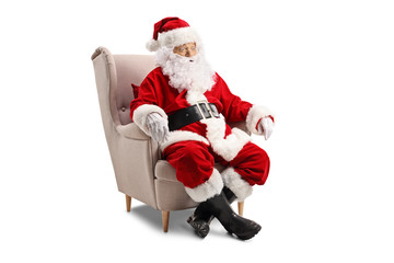 Surprised Santa Claus sitting in an armchair