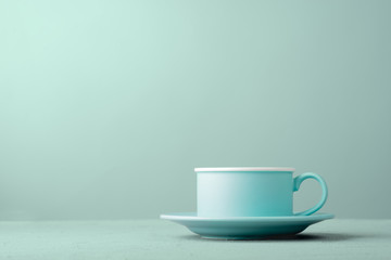 Turquoise cup on the table