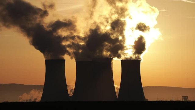 nuclear plant, cooling towers in morning light, closeup