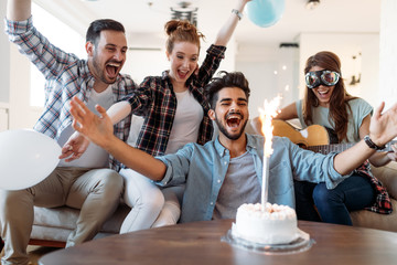 Young group of happy friends celebrating birthday