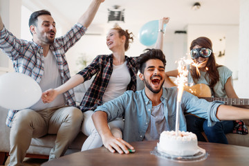 Cheerful young friends having fun on party