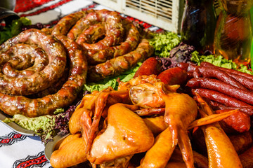 Homemade sausage on the green lettuce leaves