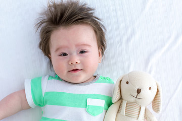 Happy baby boy lying down and resting