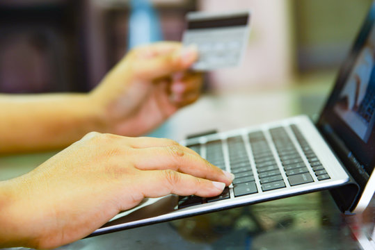 Hands holding credit card and using laptop, Online shopping
