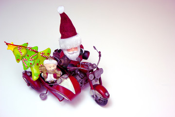 Santa Claus and polar bear on the red motorcycle are going to the Christmas party. Top view. Christmas and New Year holiday background concept. Copy space for text.