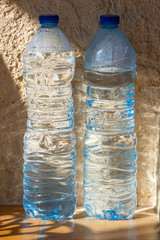Two Plastic Water Bottles Outside in the Sunlight
