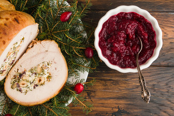 Baked turkey breast roll stuffed with feta cheese, hazelnuts, cranberries and parsley, Christmas decoration, top view - 232995379